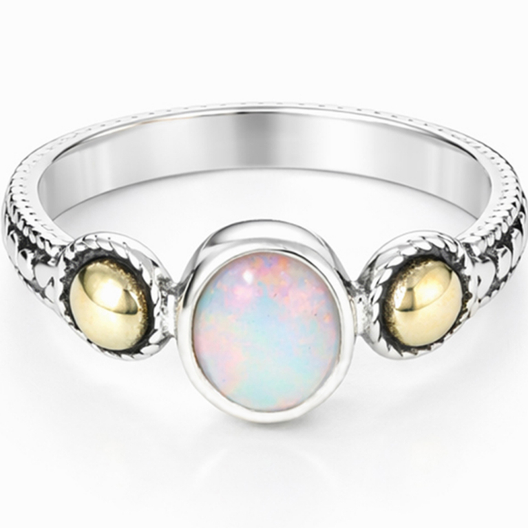 Handmade 925 sterling silver ring featuring a natural oval Ethiopian Opal in a bezel setting with gold accent beads and a hand-textured artisan band.