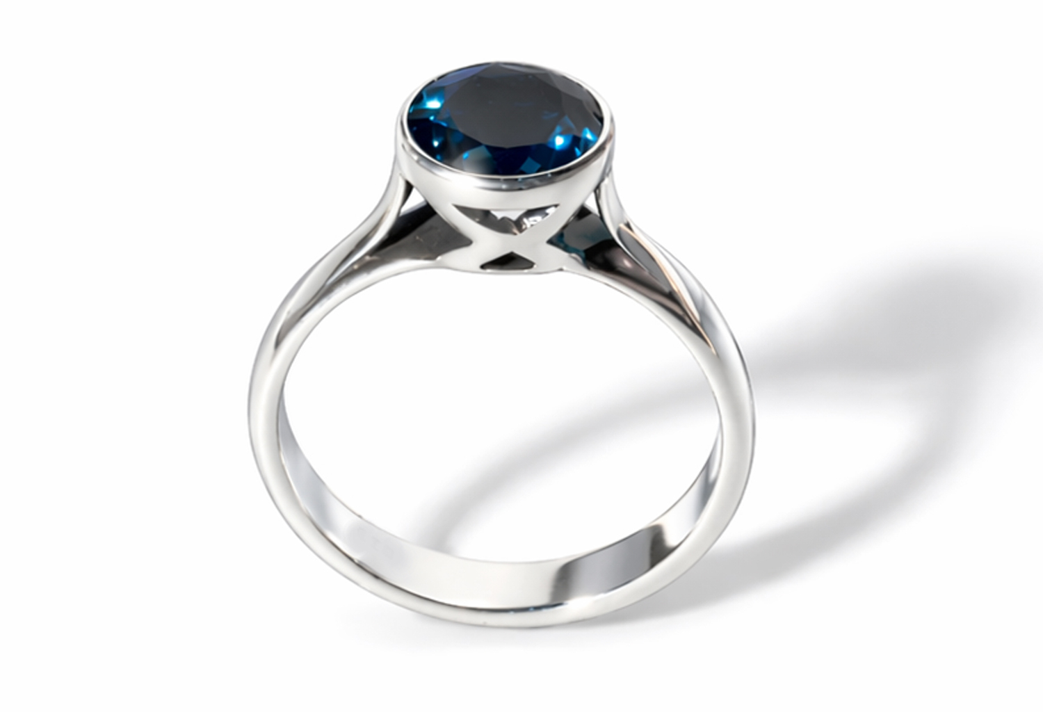 Handmade 925 sterling silver bezel solitaire ring featuring a natural round London Blue Topaz with a high mirror polish finish.