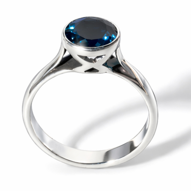 Handmade 925 sterling silver bezel solitaire ring featuring a natural round London Blue Topaz with a high mirror polish finish.