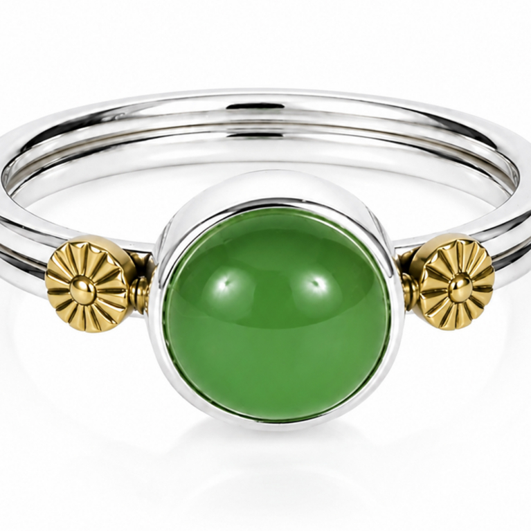 Handmade sterling silver bezel ring with a round green chalcedony cabochon gemstone and 18K gold floral accents, polished artisan statement ring on a white background.