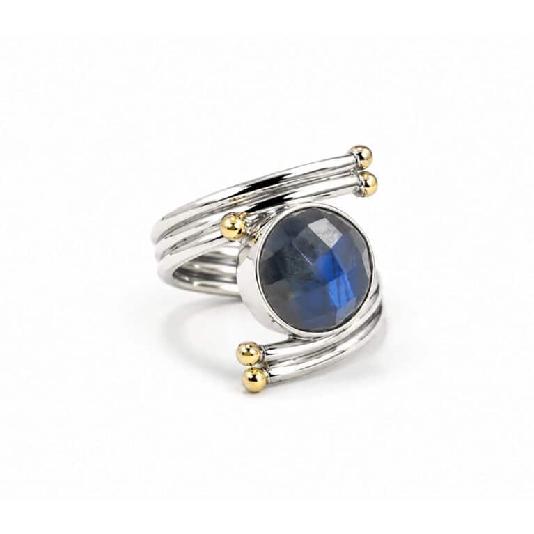 Handmade sterling silver labradorite statement ring with faceted labradorite gemstone and gold accent details.