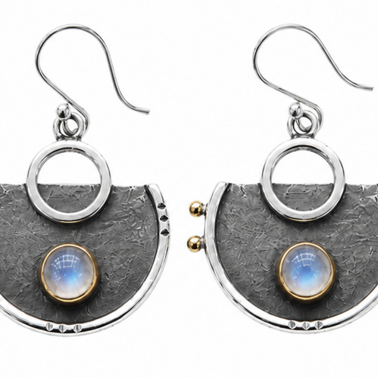 Handmade 925 sterling silver statement earrings featuring natural Moonstone cabochons in gold bezel settings with oxidized hand-textured semi-circle designs and French hooks.