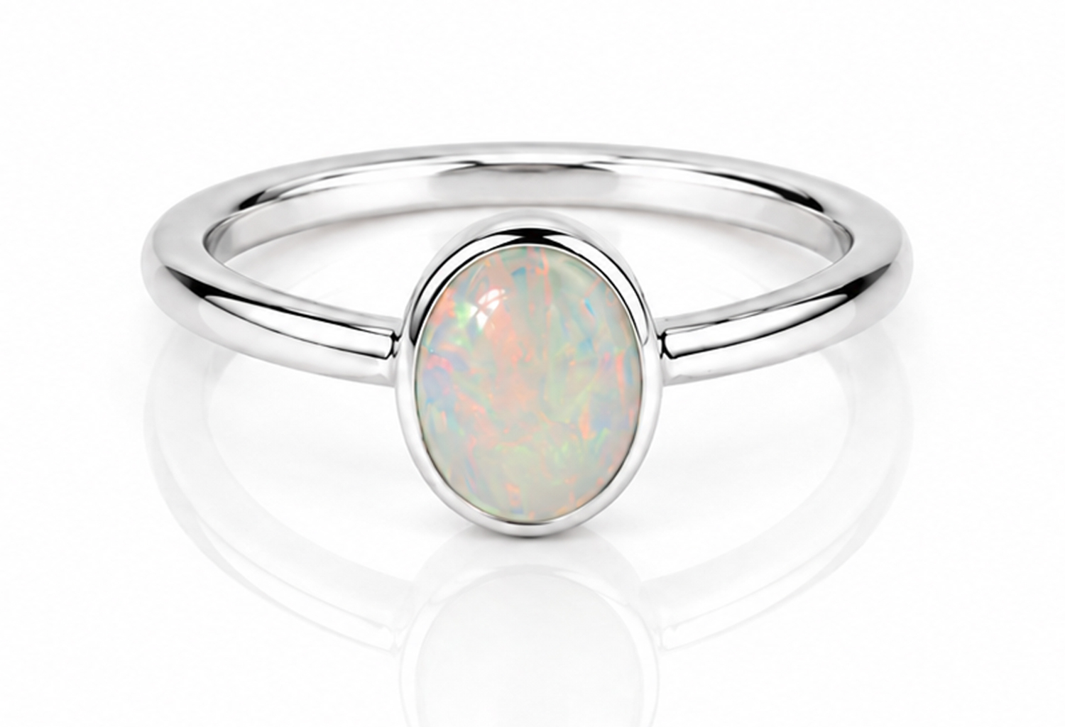 Handmade sterling silver ring featuring a genuine natural oval opal in a polished bezel setting with a minimalist 925 sterling silver band and ultra mirror finish on a white background.