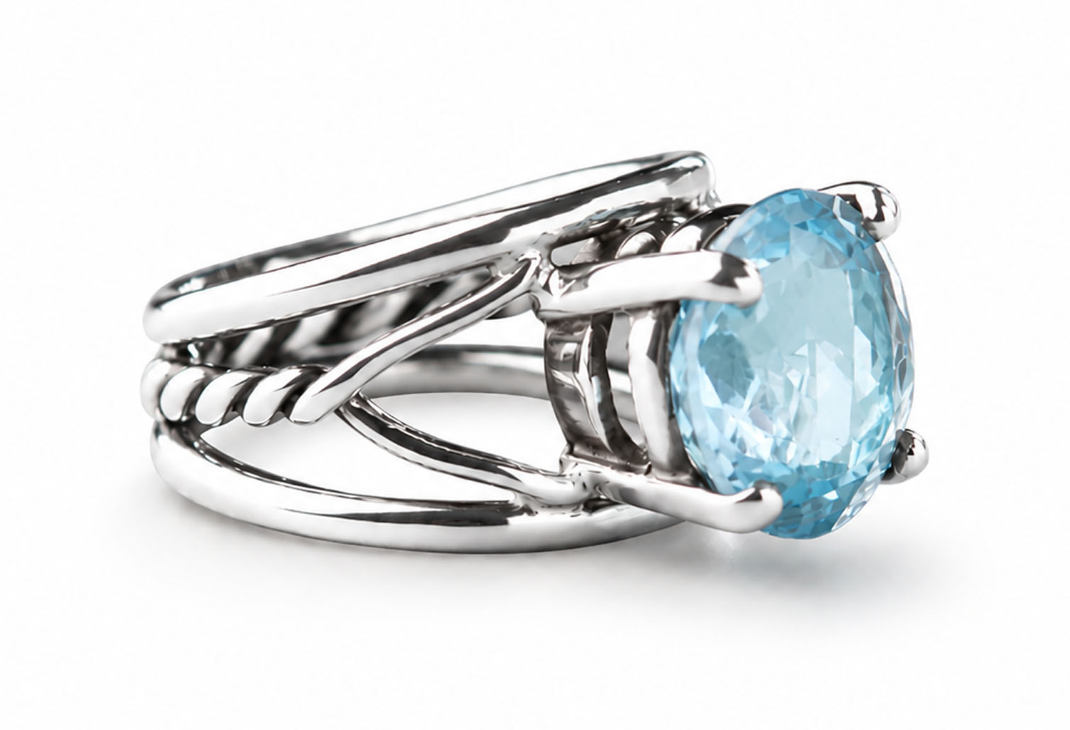 Oval blue topaz ring with a flowing split-band design in polished sterling silver.