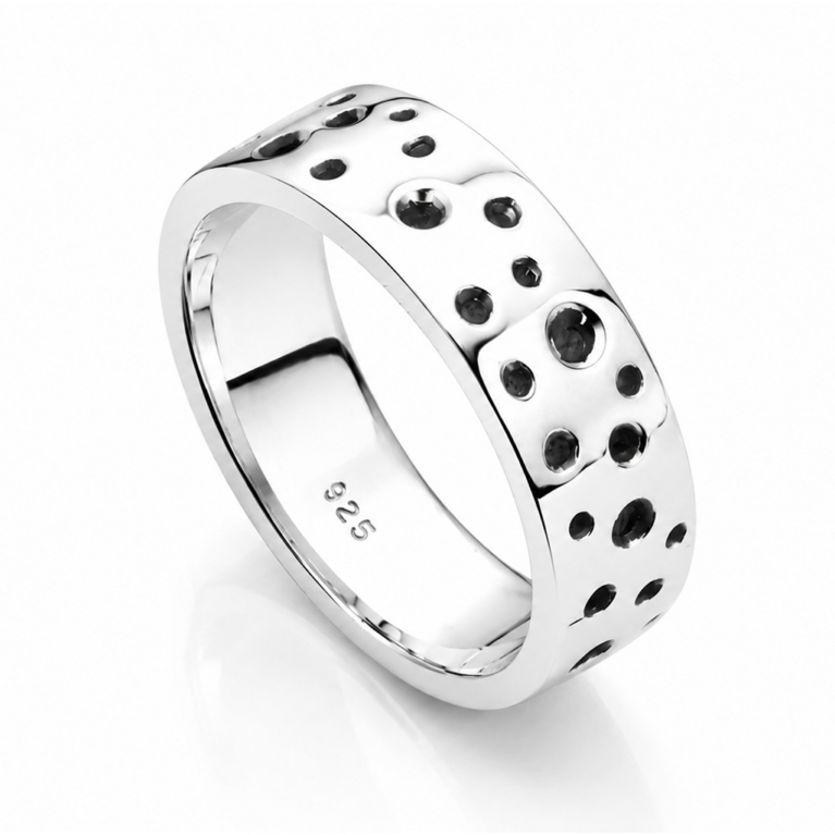 Handmade sterling silver crater ring featuring organic recessed circular detailing, oxidized accents, and an ultra mirror polished finish on a white background.
